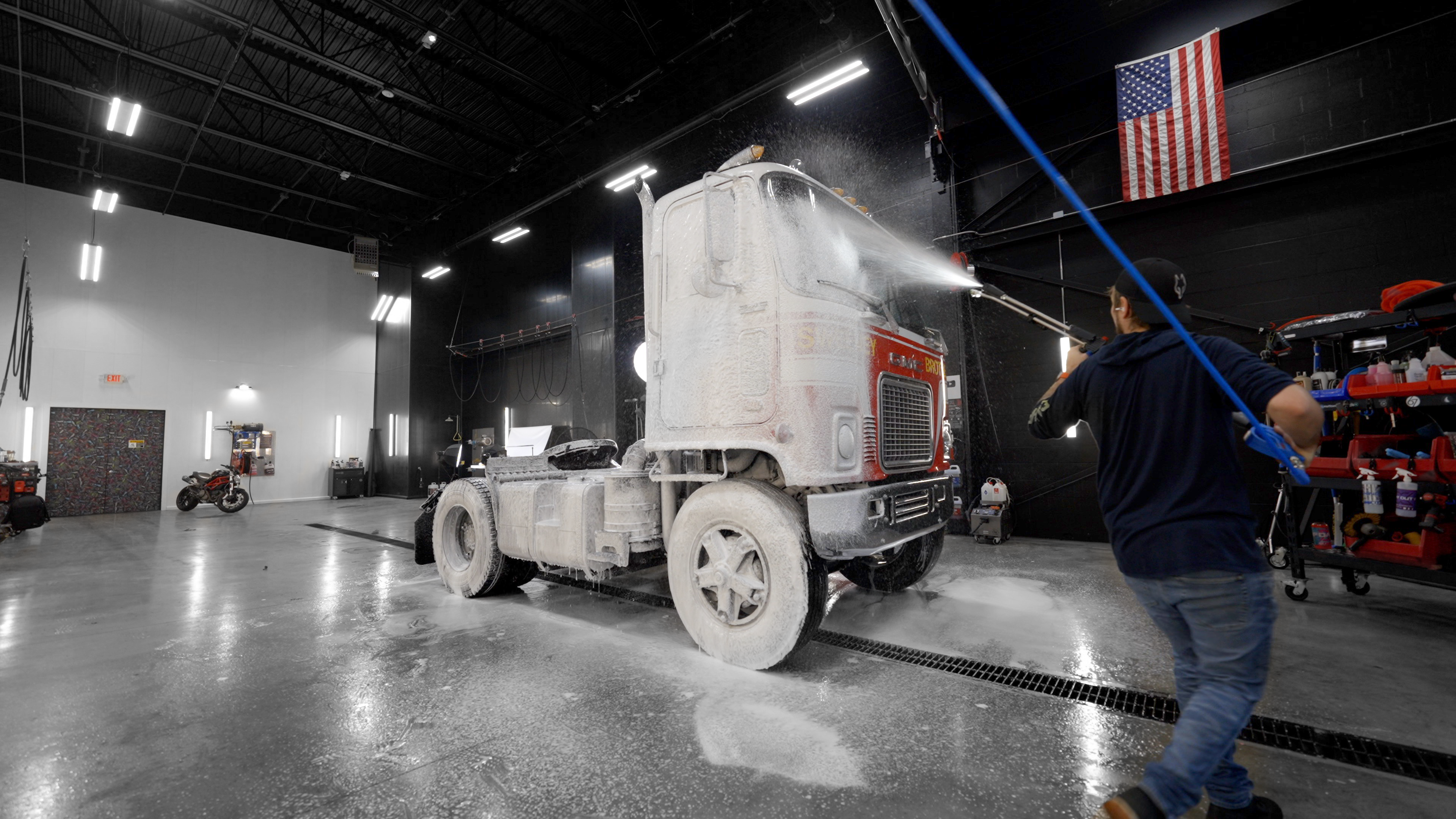 Bob in wash bay spraying foam on a truck with Freedom Foamer lance.