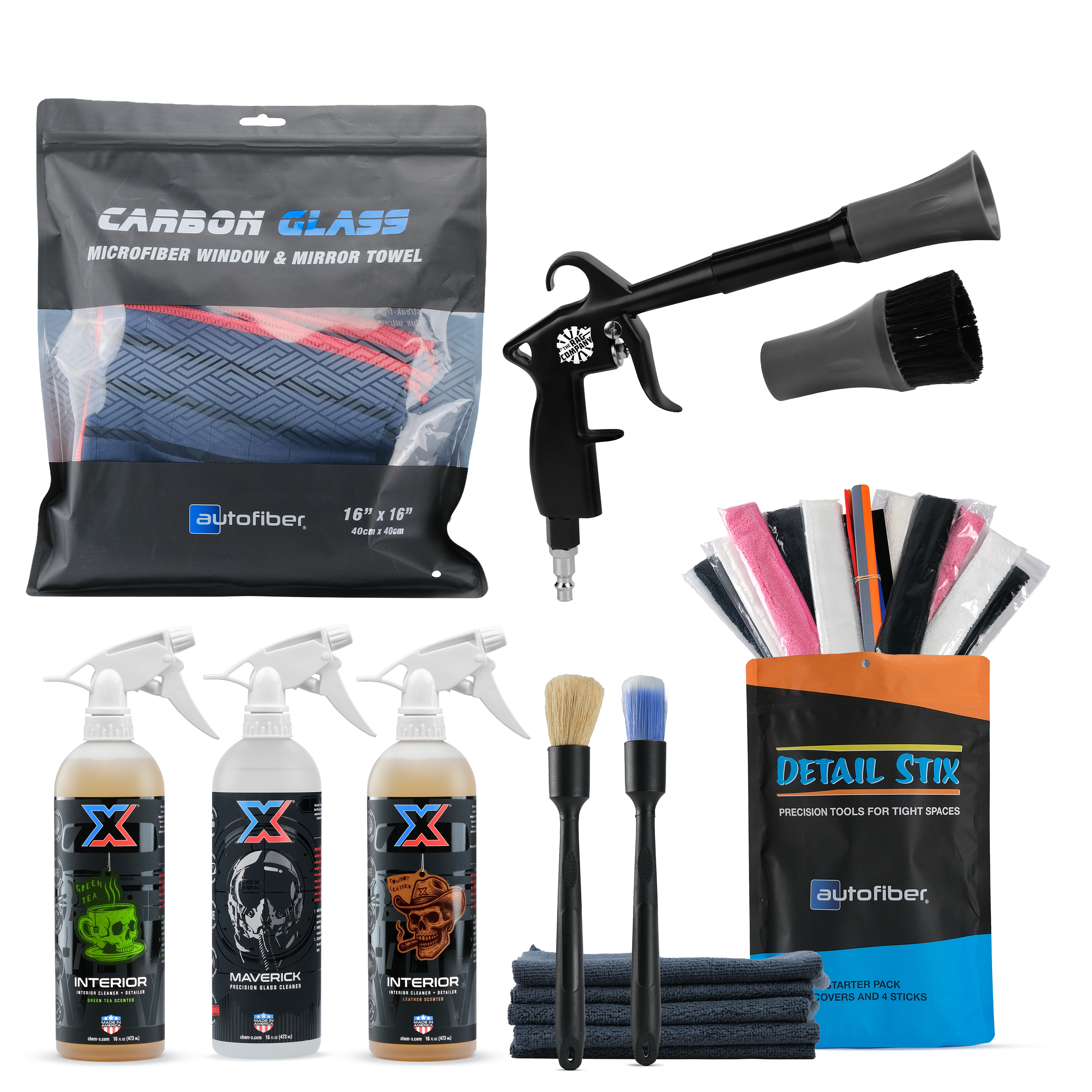 Complete interior cleaning kit on a white background, including a Carbon Glass microfiber towel pouch, a black and gray air blaster with another scrubby attachment, a 16oz bottle of orange green tea-scented interior cleaner + detailer called Interior, a 16oz bottle of clear precision glass cleaner called Maverick, a 16oz bottle of orange leather-scented interior cleaner + detailer called Interior, two small brushes, a stack of folded dark towels, and a Detail Stix bag with multiple tools sticking out.