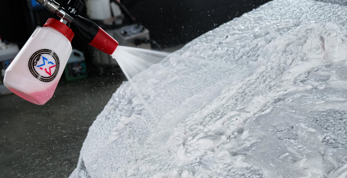 Red chem-x chrome foam cannon spraying foam onto vehicle