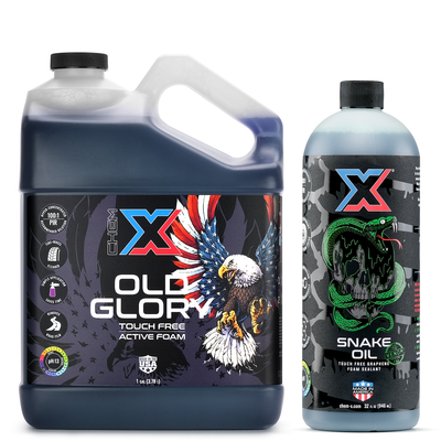 One gallon bottle of black touch free active foam vehicle wash called 'Old Glory' next to a 32 oz bottle of green touch free graphene foam sealant called 'Snake Oil' on a white background.