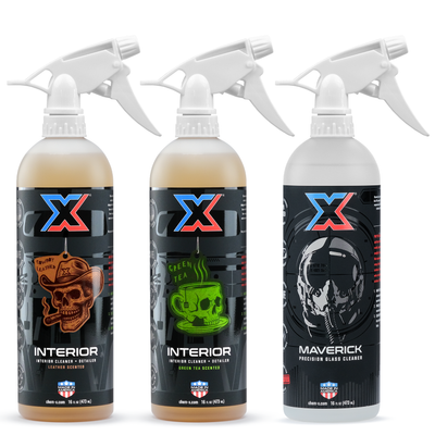 A 16oz bottle of orange leather-scented interior cleaner + detailer called Interior, a 16oz bottle of orange green tea-scented interior cleaner + detailer called Interior, and a 16oz bottle of clear precision glass cleaner called Maverick, all with white tolco trigger sprayers, on a white background.