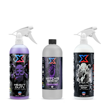 Three Chem-X bottles shown on a plain white background: Heavy Duty tire cleaner and degreaser with purple liquid and a white tolco sprayer, Witch's Brew iron and rust remover has a frosted bottle with black cap, and Death Grip tire and trim dressing with white liquid and a white tolco sprayer.