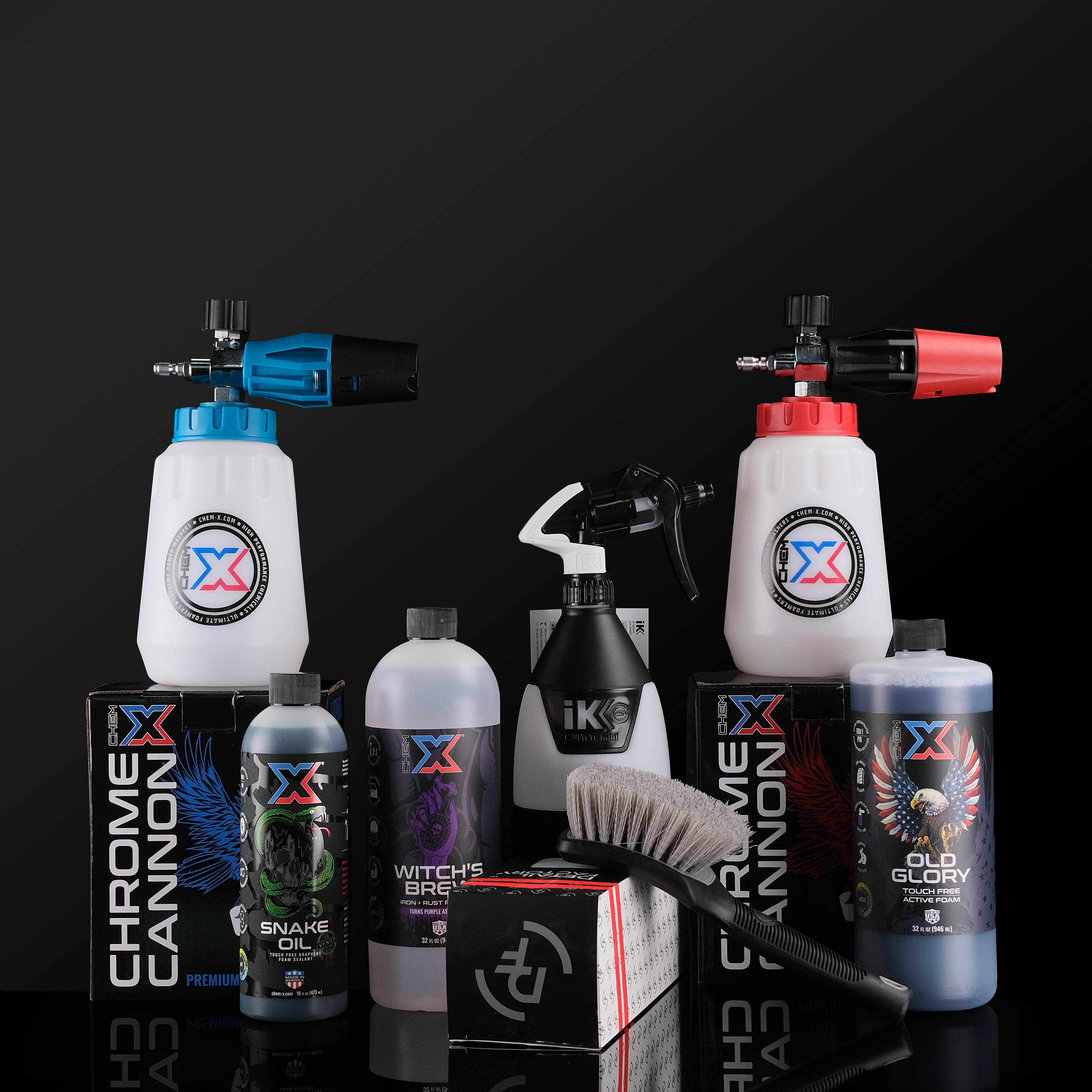 Collection of cleaning products including soap bottles, spray bottles, foam cannons, and a brush on a black background
