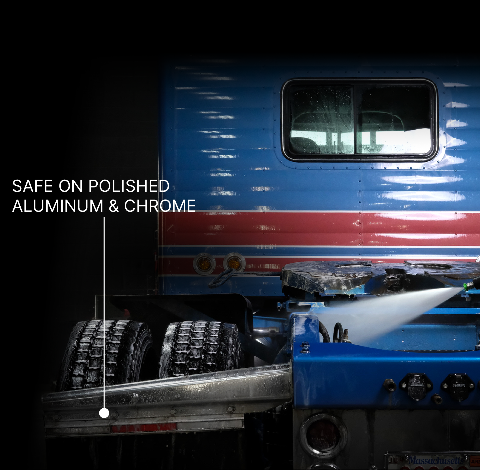 A close-up of a blue and red truck body with a power washer nozzle cleaning the surface. White text on the left reads 'SAFE ON POLISHED ALUMINUM & CHROME' with a pointer line toward the cleaned area.
